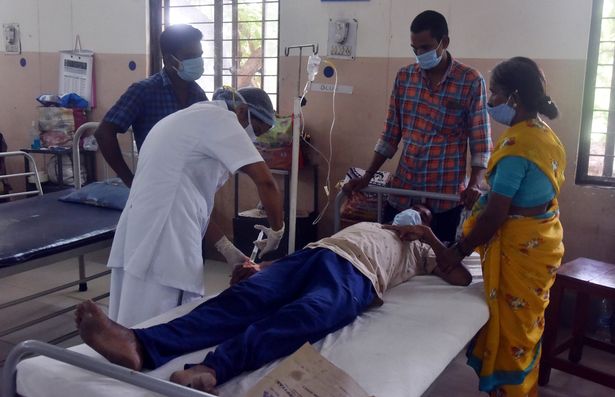 A medical worker treats a patient infected with mucormycosis