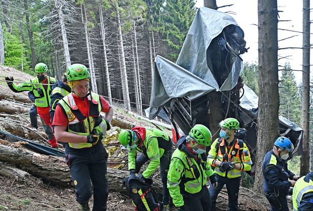 Carabinieri and Soccorso Alpino forces inspect the site where the Stresa-Alpino-Mottarone cable car crashed to the ground