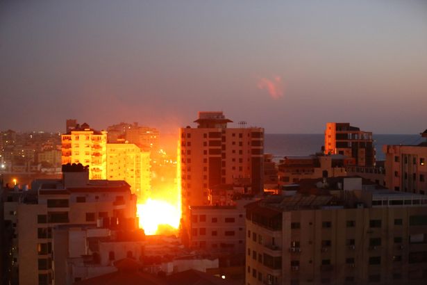 Smoke rise from buildings as Israeli fighter jets pounded a Palestinian building