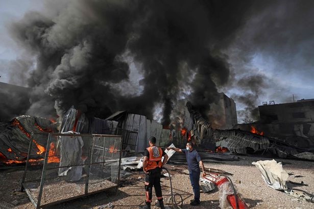 Palestinian firefighters douse a huge fire at the Foamco factory east of Jabalia in the Gaza Strip on May 17