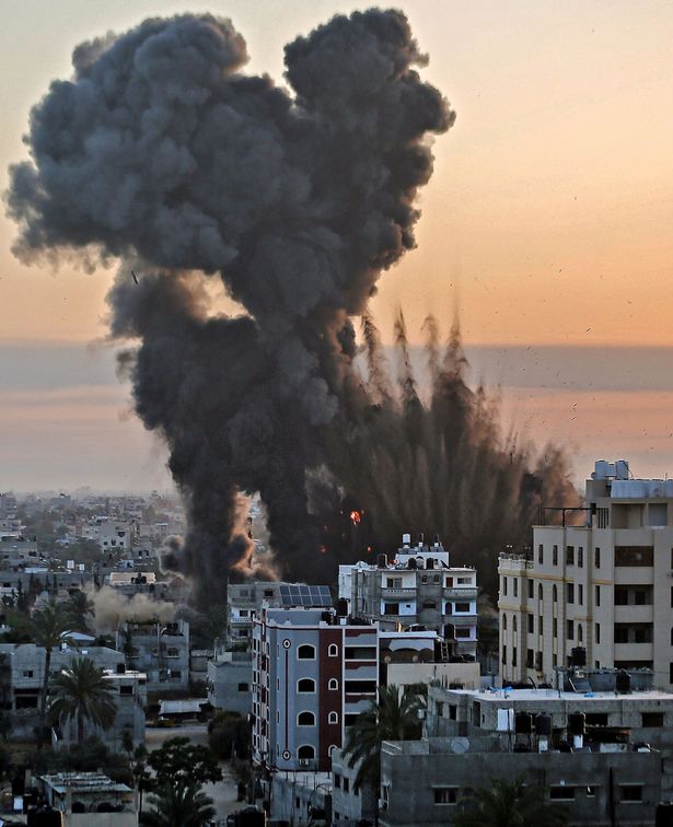 Black smoke billows after a series of Israeli airstrikes targeted Khan Yunis in the southern Gaza strip, early on May 12, 2021