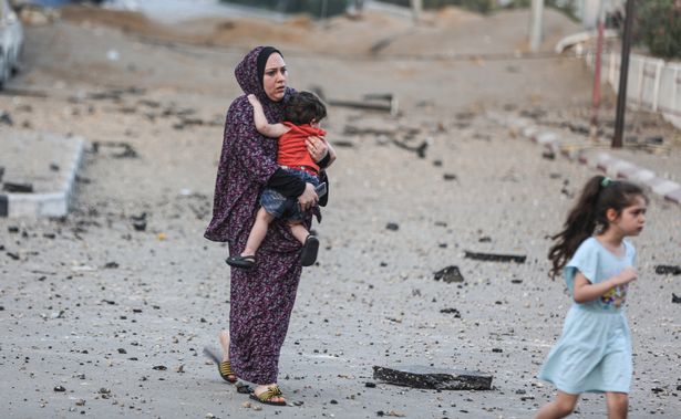 Palestinians leave their neighbourhood to head to a safer location as Israeli warplanes continue air strikes on the Gaza Strip