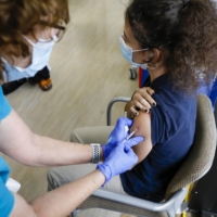 A teenager is given the Pfizer COVID-19 vaccine in Florida on May 18. | BLOOMBERG