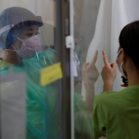 COVID-19 infections are declining in some areas including Tokyo and Osaka but 'on the whole the situation is highly unpredictable,' Prime Minister Yoshihide Suga said. | REUTERS