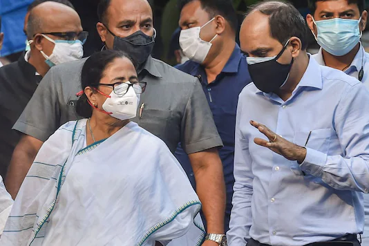 Mamata Banerjee interacts with health officials at a state government-run Covid hospital in Kolkata. (PTI)