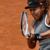 Naomi Osaka returns a shot to Jessica Pegula during their match of the Women's Italian Open at Foro Italico on May 12 in Rome. On Wednesday Osaka said will not take questions from the press at this year's French Open. | AFP-JIJI