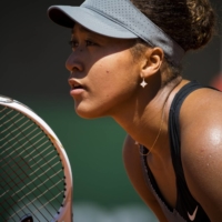 Naomi Osaka awaits a serve in her French Open first round match against Patricia Maria Tig at Court Philippe Chatrier in Paris on Sunday. | PETE KIEHART / THE NEW YORK TIMES