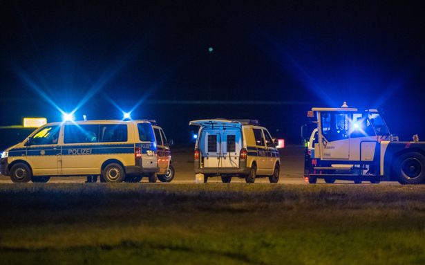 Federal police check the aircraft after an unscheduled landing at Berlin