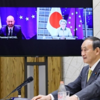 Prime Minister Yoshihide Suga attends a virtual conference with European Union leaders on Thursday. | CABINET PUBLIC RELATIONS OFFICE / VIA KYODO