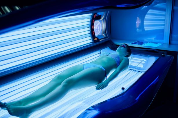 Stock image of woman using a sunbed