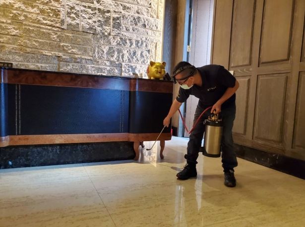 person cleaning eatery