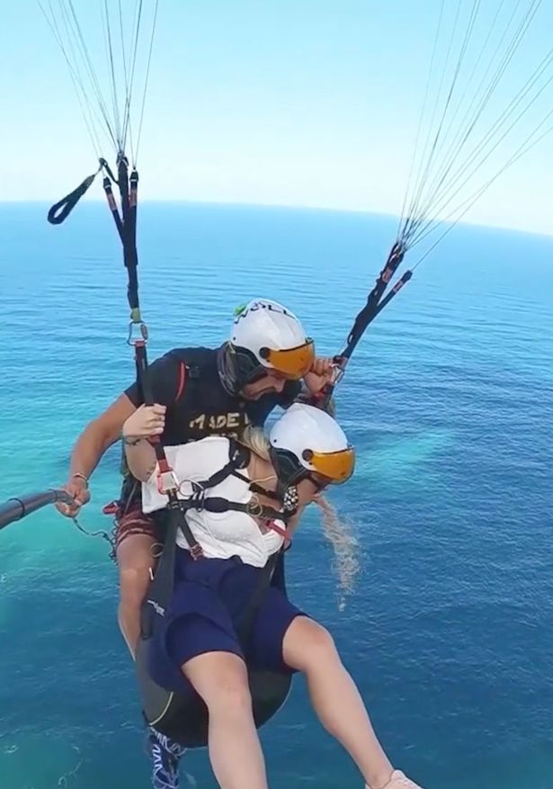 Woman and instructor paragliding