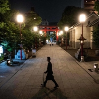 A man walks near the Tomioka Hachiman Shrine in Tokyo on Friday. | AFP-JIJI