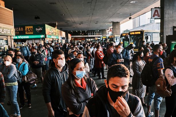 Commuters line up to board buses at Rodoviaria do Plano Piloto in Brasilia, Brazil