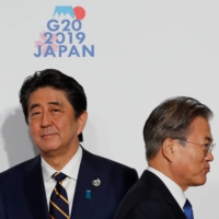 Prime Minister Shinzo Abe and South Korean President Moon Jae-in at the G20 leaders summit in Osaka in June 2019. Leaders of Japan and South Korea haven't held a summit since December of that year amid frosty ties.  | REUTERS