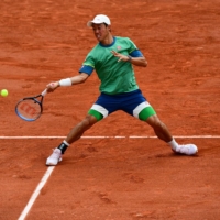 Kei Nishikori hits a return to Switzerland's Henri Laaksonen during their match on Friday in Paris.  | AFP-JIJI