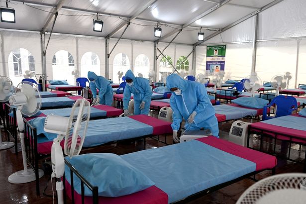 Health workers arrange oxygen concentrator machines at a newly inaugurated Covid-19 coronavirus centre in Chennai