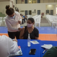 A health care worker administers a dose of the Sputnik V COVID-19 vaccine at the National Secretary of Sports of Paraguay in Asuncion on Friday. | BLOOMBERG