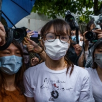 Activist Agnes Chow (center) leaves prison in Hong Kong on Saturday. | BLOOMBERG