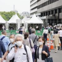 Older people outside a large-scale state-run COVID-19 vaccination center in Tokyo last week. | KYODO 
