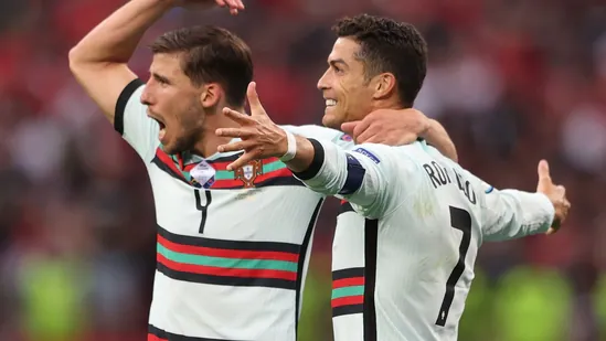 Portugal's Cristiano Ronaldo celebrates scoring their third goal with Ruben Dias Pool via REUTERS/Alex Pantling(Pool via REUTERS)