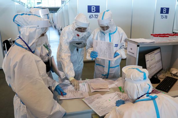 Medics wear protective suits in the 'red zone' of a temporary Covid-19 hospital in St Petersburg