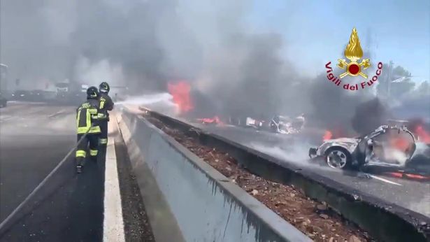 Firefighters doused the vehicles with water as black smoke billowed into the sky