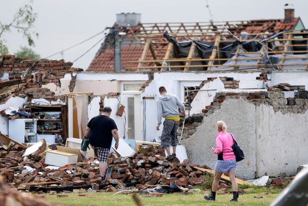 Survivors assess the damage done to their homes