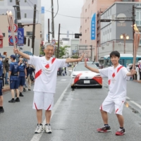 The Olympic torch relay in Ishinomaki, Miyagi Prefecture, on Saturday | KYODO