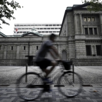 The Bank of Japan is seen keeping in place its negative interest rate and asset purchase settings at next week's meeting, a survey shows. | BLOOMBERG