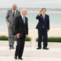 Prime Minister Yoshihide Suga (center) and U.S. President Joe Biden (front left) are seen along with other Group of Seven leaders in Cornwall, United Kingdom, on Friday. | POOL / VIA KYODO