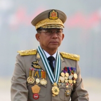 Myanmar's junta chief Gen. Min Aung Hlaing, who ousted the elected government in a coup on Feb. 1, presides over an army parade on Armed Forces Day in Naypyitaw, Myanmar, in March.  | REUTERS