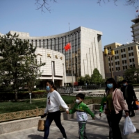 The People's Bank of China headquarters in Beijing. The central bank has said it won’t significantly tighten monetary policy, unlike its counterparts in other emerging economies.  | REUTERS