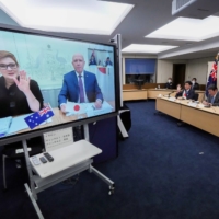 Japanese Foreign Minister Toshimitsu Motegi (right) and Defense Minister Nobuo Kishi, attend a video conference with Australian Foreign Minister and Minister for Women Marise Payne (left) on screen, and Australian Defense Minister Peter Dutton at the Foreign Ministry in Tokyo on Wednesday. | POOL / VIA REUTERS