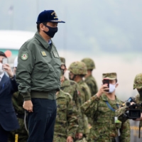 Defense Minister Nobuo Kishi attends a live fire exercise at the Ground Self-Defense Force's training grounds in Gotemba, Shizuoka Prefecture, on May 22.  | POOL / VIA REUTERS