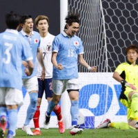 Kento Hashimoto celebrates after scoring for Japan's senior national team during a match against the nation's U-24 side at Sapporo Dome on Thursday. | KYODO