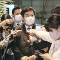 Yasufumi Tanahashi speaks to reporters at the Prime Minister's Office on Friday. | KYODO