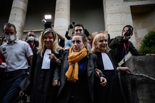 Valerie Bacot (C) leaves Chalon-sur-Saone Courthouse, flanked by relatives and lawyers applauded and congratulated by passers-by, in Chalon-sur-Saone, central-eastern France, on June 25, 2021 at the end of her trial on charges of murdering her stepfather turned husband