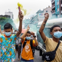 Protesters march in Yangon, Myanmar, on Tuesday during a demonstration against the military coup. | AFP-JIJI