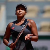 Naomi Osaka celebrates after winning against Romania's Patricia Maria Tig on Day 1 of the French Open in Paris. | AFP-JIJI