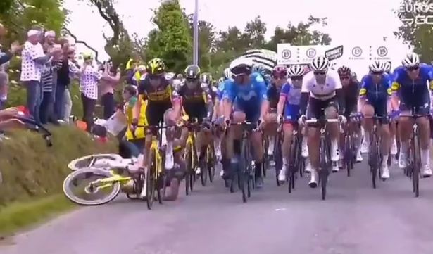 A cycling spectator who caused one of the worst crashes in the history of the Tour de France faces up to a year in prison after running away from the massive pile-up.
The female fan reached out into the road with a placard aimed at the TV cameras during the first stage of this year’s world-famous racefrom Brest to Landeneau.
The spectator appeared oblivious to the danger posed as Jumbo-Visma’s Tony Martin struck the sign and hit the deck to cause a colossal pile-up of stricken riders and broken bikes.