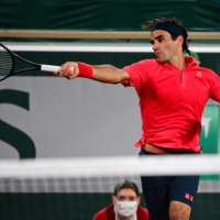 Roger Federer hits a return against Dominik Koepfer during their third-round match at the French Open in Paris on Sunday. | AFP-JIJI