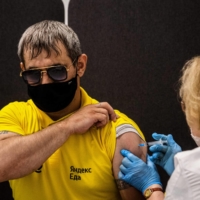 A man receives a dose of Russia's Sputnik V vaccine at a center in Moscow on Friday.  | AFP-JIJI