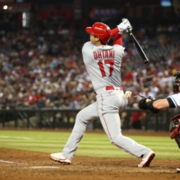 The Los Angeles Angels' Shohei Ohtani hits a double in the seventh inning against the Arizona Diamondbacks at Chase Field in Phoenix on Friday.  | USA TODAY / VIA REUTERS