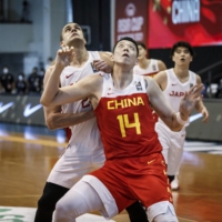 China's Shen Zijie and Japan's Gavin Edwards compete for a rebound during their FIBA Asia Cup qualifying game in Pampanga, Philippines | COURTESY OF FIBA ASIA CUP
