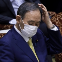 Prime Minister Yoshihide Suga attends an audit committee session at the upper house of parliament in Tokyo on Monday. | BLOOMBERG