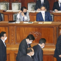 Lawmakers vote on a no-confidence motion against Prime Minister Yoshihide Suga at a Lower House plenary session of the Diet on Tuesday.   | KYODO