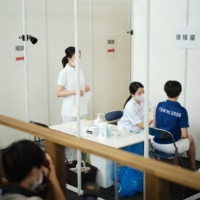 Medical and support staff for the Tokyo Games receive their first dose of the coronavirus vaccine in the observatory of the Tokyo Metropolitan Government building on Friday. | RYUSEI TAKAHASHI
