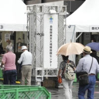 People visit the mass vaccination center run by the Self-Defense Forces in Tokyo on Monday. | KYODO