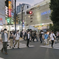 People walk near Tokyo's Shinjuku Station on Saturday. | KYODO